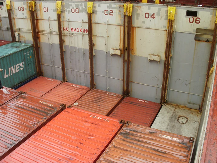 Containers stacked along cell guides 